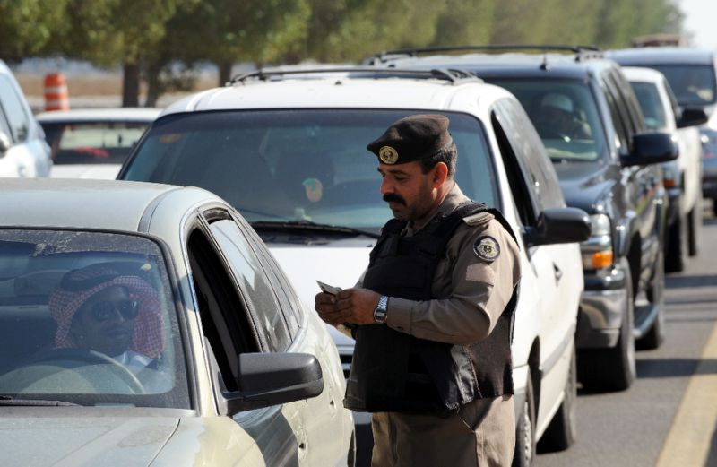 a saudi policeman checks the id card of a driver at a checkpoint in the mostly shiite qatif region photo afp