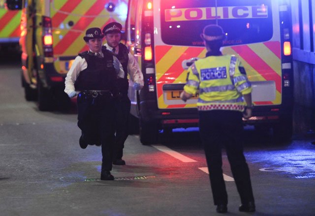 police officers run at the scene of an apparent terror attack on london bridge in central london on june 3 2017 photo afp