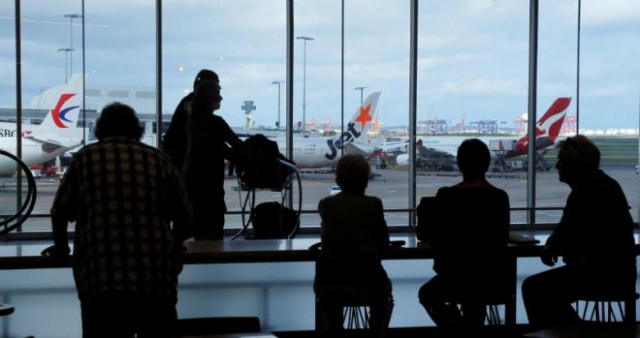 passengers wait to board their flights at the sydney international airport photo reuters passengers wait to board their flights at the sydney international airport photo reuters