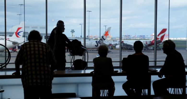 passengers wait to board their flights at the sydney international airport photo reuters