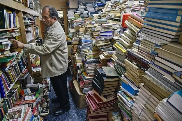 jose alberto gutierrez checks books stacked in his library on the first floor of his house in bogota photo afp jose alberto gutierrez checks books stacked in his library on the first floor of his house in bogota photo afp