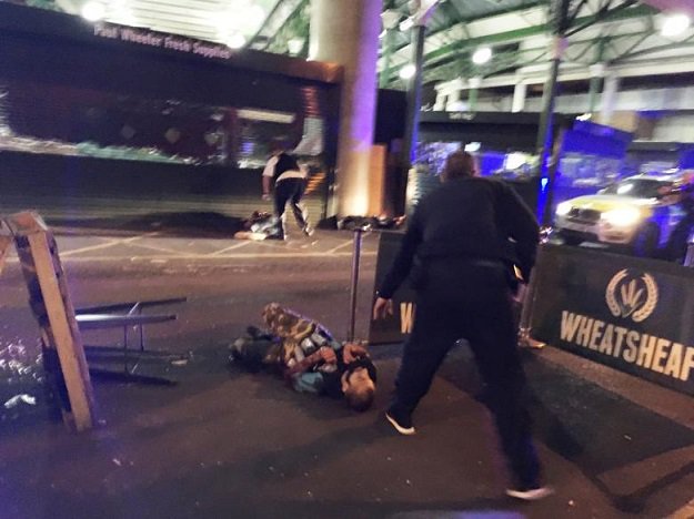 a man is seen on the ground after armed police officers opened fire on suspected attackers in borough market photo reuters