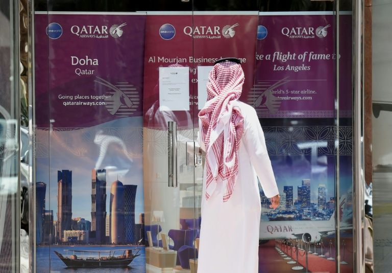 a man stands outside a qatar airways branch in the saudi capital riyadh after it was forced to suspended all flights to saudi arabia photo afp