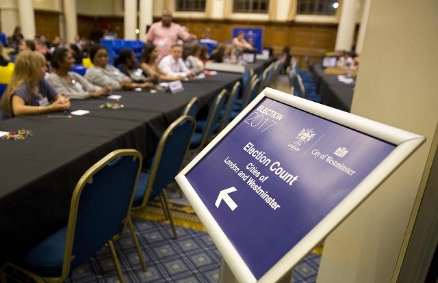 counting staff wait for the arrival of the first ballot boxes at the counting centre at the methodist central hall in westminster london on june 8 2017 after the polls closed in the british general election prime minister theresa may 039 s conservatives are set to lose their overall majority after britain 039 s general elections an exit poll showed on thursday after voting closed photo afp