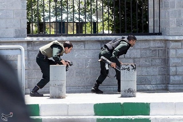 members of iranian forces take cover during an attack on the iranian parliament in central tehran iran june 7 2017 photo reuters