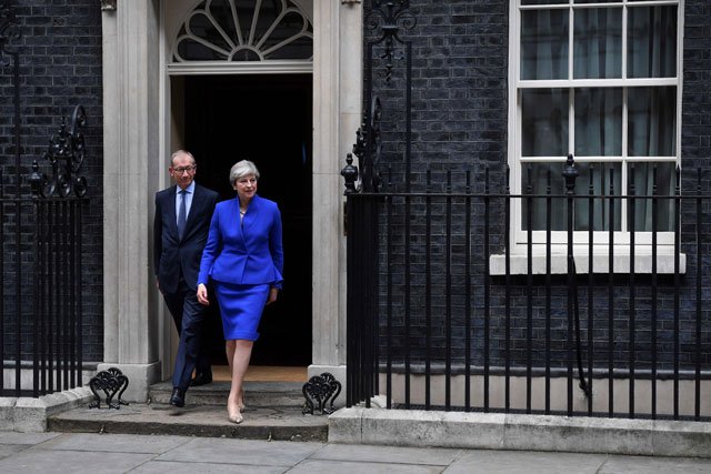 britain 039 s prime minister and leader of the conservative party theresa may r accompanied by her husband philip leaves 10 downing street in central london on june 9 2017 en route to buckingham palace to meet queen elizabeth ii photo reuters