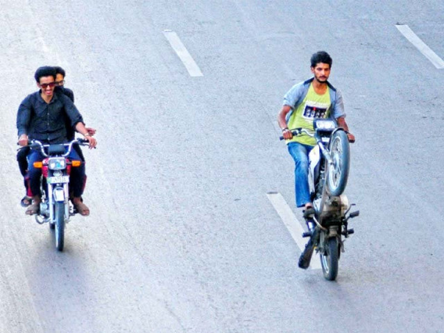 people take part in an illegal wheeling event held each day on benazir bhutto shaheed road near new town police station photo waseem imran express people take part in an illegal wheeling event held each day on benazir bhutto shaheed road near new town police station photo waseem imran express