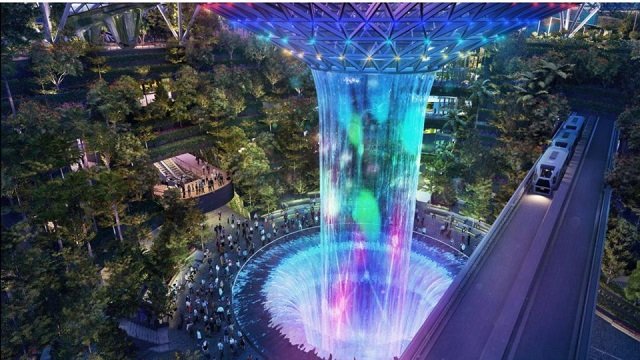 the jewel changi airport which is expected to open in 2019 will feature a futuristic architectural landscape design consisting of an amusement park a waterfall and even indoor clouds for holidaymakers photo jewel changi airport