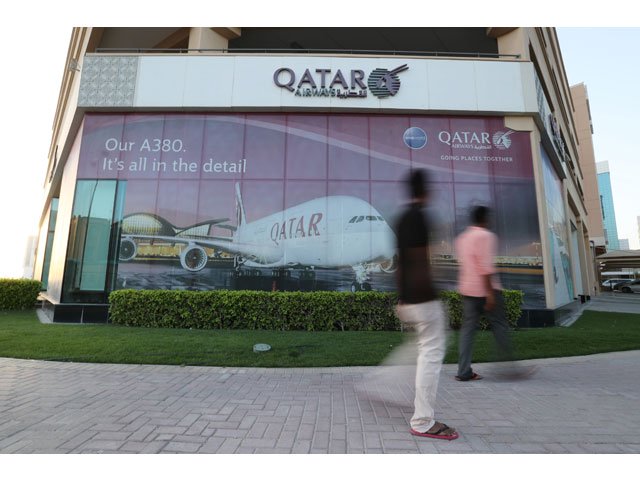 people walk past the qatar airways office in manama bahrain june 8 2017 picture taken june 8 2017 photo reuters