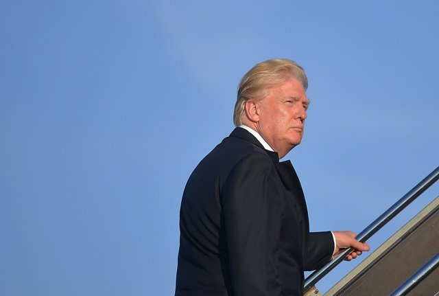 us president donald trump makes his way to board air force one before departing from newark liberty airport in newark new jersey on june 11 2017 photo afp