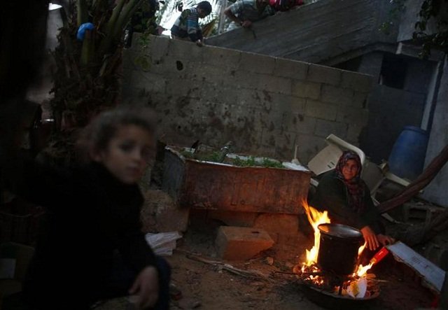 a palestinian woman burns firewood to cook at her house in the northern gaza strip photo reuters