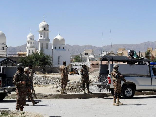 soldiers stand guard at the site where a chinese couple was kidnapped in the neighbourhood of jinnah town in quetta on may 24 photo afp