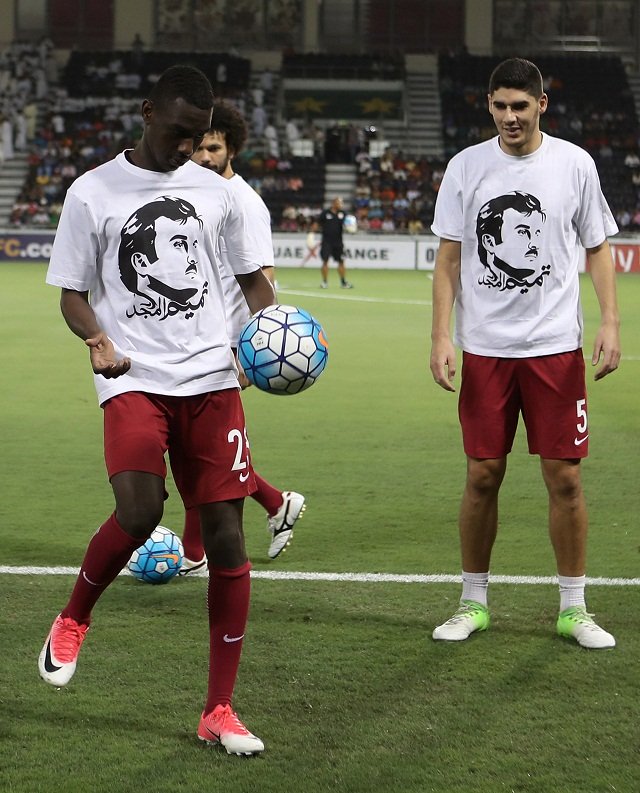 qatar 039 s national team players karim boudiaf r and ali almoez wear t shirts bearing portraits of emir sheikh tamim bin hamad al thani in support the qatari leader in the ongoing diplomatic crisis surrounding qatar and other gulf countries as they warm up prior to their world cup 2018 asia qualifying football match between qatar and south korea at the jassim bin hamad stadium in doha on june 13 2017 photo afp