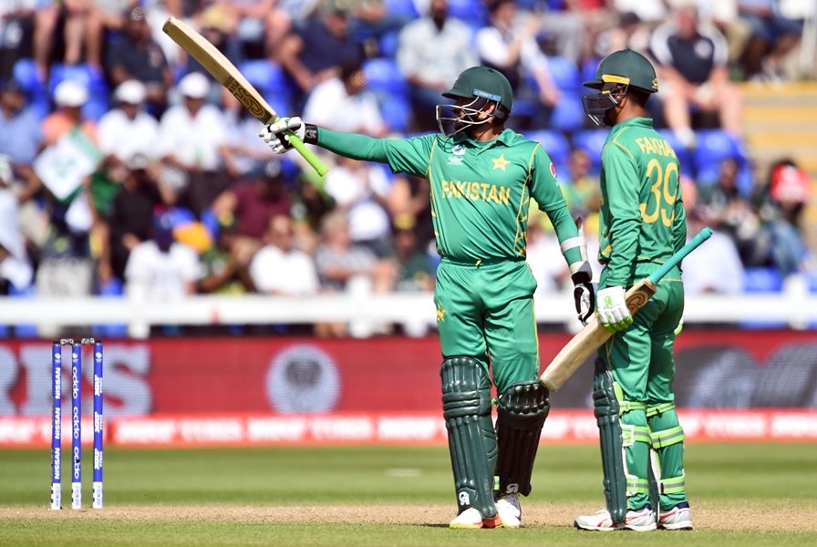 pakistan 039 s fakhar zaman r looks on as pakistan 039 s azhar ali celebrates his half century during the icc champions trophy semi final cricket match between england and pakistan in cardiff on june 14 2017 photo afp