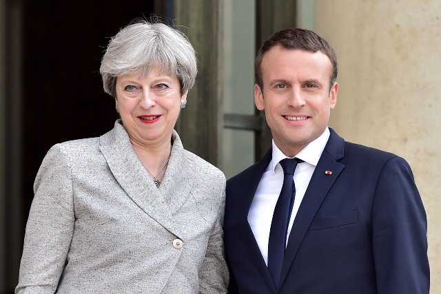 britain 039 s prime minister theresa may l is greeted by france 039 s president emmanuel macron ahead of a meeting at the elysee palace in paris on june 13 2017 photo afp