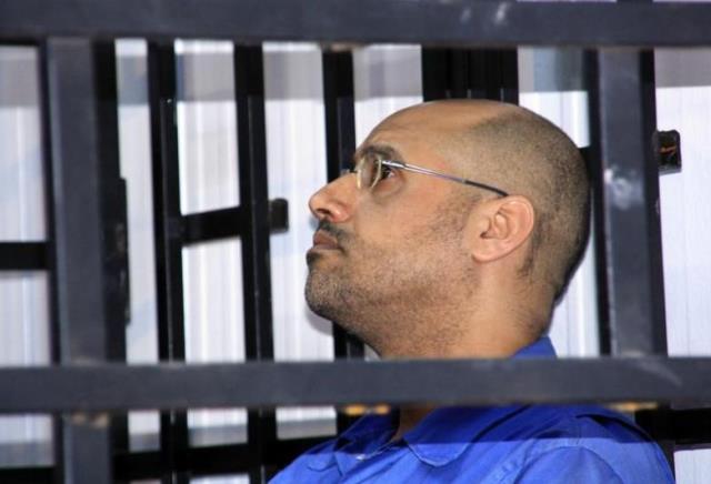 saif al islam gaddafi son of late libyan leader muammar gaddafi attends a hearing behind bars in a courtroom in zintan may 25 2014 photo reuters