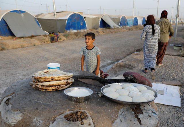 displaced iraqi family from mosul bake bread for their iftar during the muslim holy month of ramadan at a refugee camp al khazir in the outskirts of erbil iraq june 10 2017 photo reuters