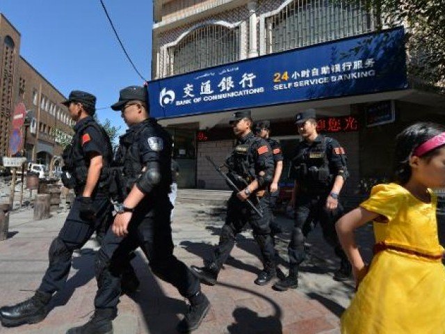 chinese armed police patrol the streets of the muslim uighur quarter in urumqi after a series of terrorist attacks hit xinjiang province on june 29 2013 photo afp