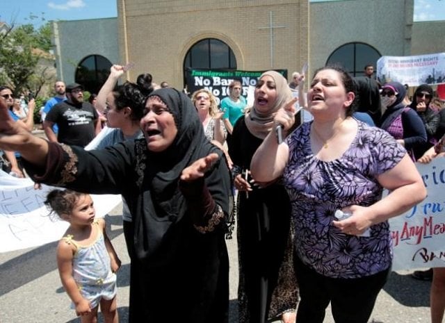 a group of women react as they talk about family members seized on sunday by immigration and customs enforcement agents during a rally outside the mother of god catholic chaldean church in southfield michigan us june 12 2017 photo reuters