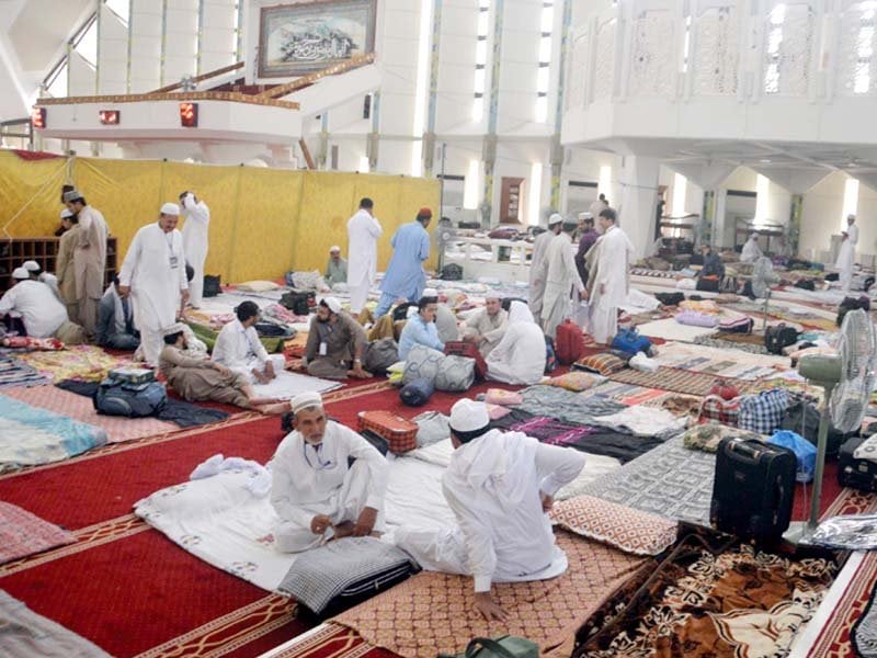 people come to attend the aitekaf in faisal mosque while security officials check their luggage photo mudassir raja express