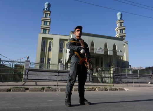 an afghan policeman stands guard outside a mosque where a suicide bomber detonated a bomb in kabul afghanistan photo reuters
