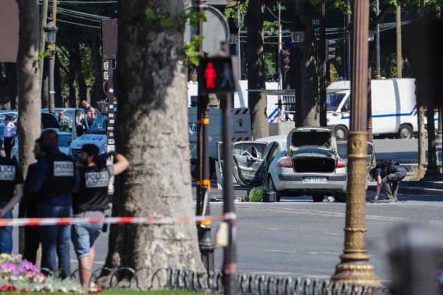 authorities quickly sealed off the world famous champs elysees avenue after a 31 year old man on a terror watchlist rammed a car loaded with guns and a gas bottle into a police photo afp