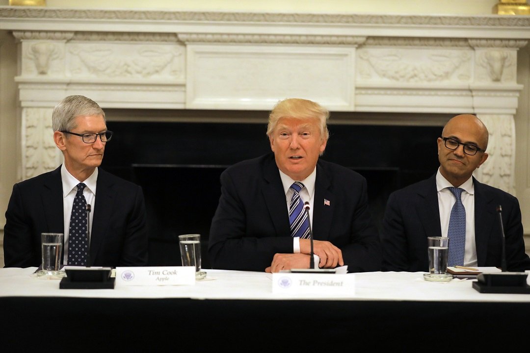 u s president donald trump participates in an american technology council roundtable accompanied by tim cook ceo of apple l and satya nadella ceo of microsoft corporation photo reuters