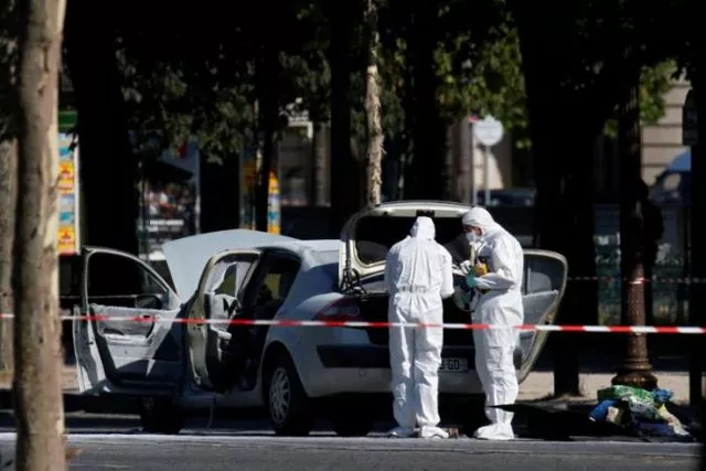 members of the scientific police inspect a burned car at the scene of an incident in which a car rammed a gendarmerie van on the champs elysees avenue in paris france june 19 2017 photo reuters members of the scientific police inspect a burned car at the scene of an incident in which a car rammed a gendarmerie van on the champs elysees avenue in paris france june 19 2017 photo reuters