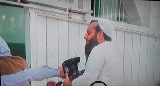 a cleric from the mosque snatching the camera from the tv crew in a screengrab from a video made by the newsmen photo express