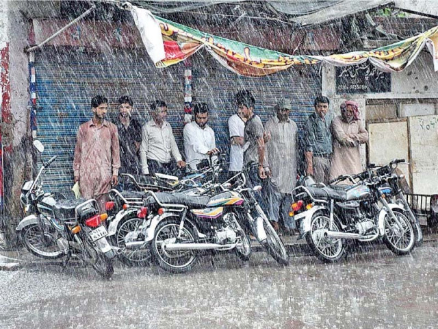 people take shelter under shade during rainfall in sialkot photo app people take shelter under shade during rainfall in sialkot photo app