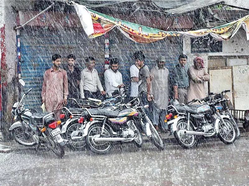 people take shelter under shade during rainfall in sialkot photo app people take shelter under shade during rainfall in sialkot photo app