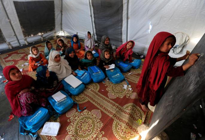 afghan refugee children attend a class at a refugee camp photo reuters