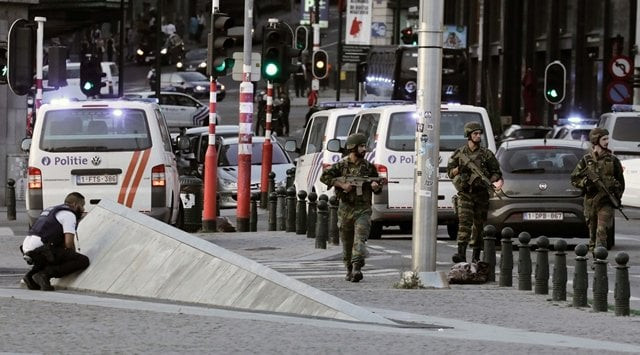 police officials and soldiers stand alert in a cordoned off area outside gare centrale in brussels photo afp police officials and soldiers stand alert in a cordoned off area outside gare centrale in brussels photo afp