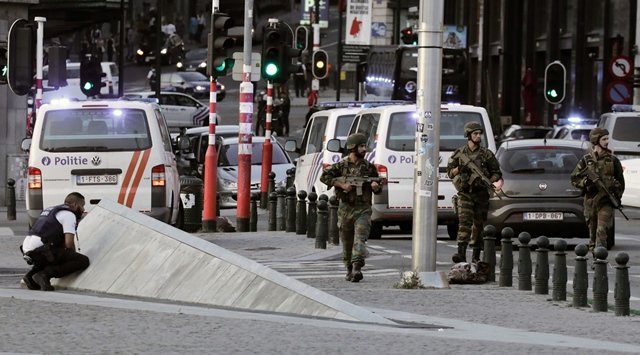 police officials and soldiers stand alert in a cordoned off area outside gare centrale in brussels photo afp