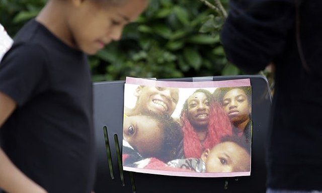 a girl walks past a memorial outside the apartment where charleena lyles was shot and killed by police on monday photo ap