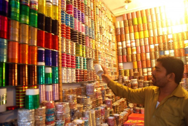 shopkeeper sets up shop awaiting customers sales are higher for shops with bright lights say shopkeepers photo israr ul haq shopkeeper sets up shop awaiting customers sales are higher for shops with bright lights say shopkeepers photo israr ul haq
