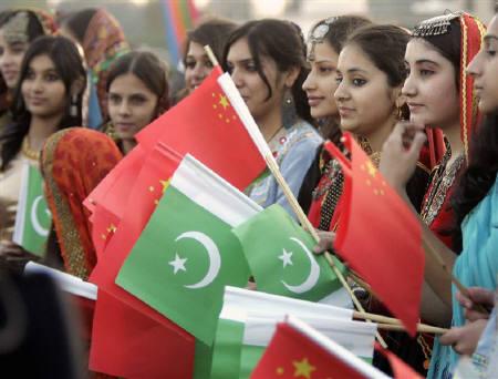 school children waving pakistan and china flags at an event photo reuters