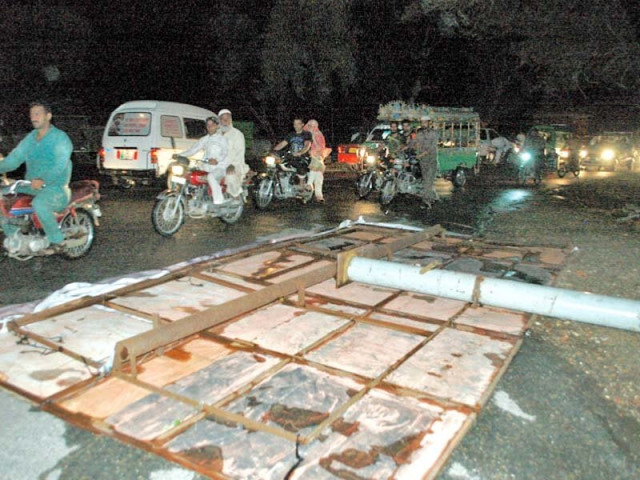 a billboard fell on a road due to strong winds in rahim yar khan photo express a billboard fell on a road due to strong winds in rahim yar khan photo express