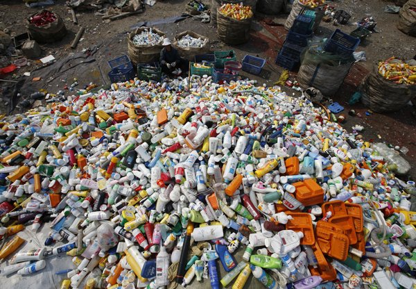 a worker separates bottles at a recycling depot photo reuters