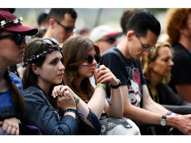 revellers observe a minute of silence in honour of those affected by recent events in manchester and london in front of the pyramid stage at worthy farm in somerset during the glastonbury festival in britain june 23 2017 photo reuters