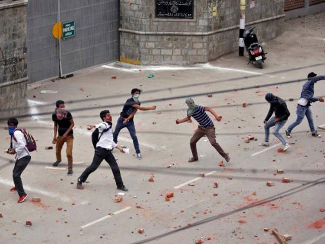 demonstrators throw stones towards the indian police during a protest in srinagar photo reuters