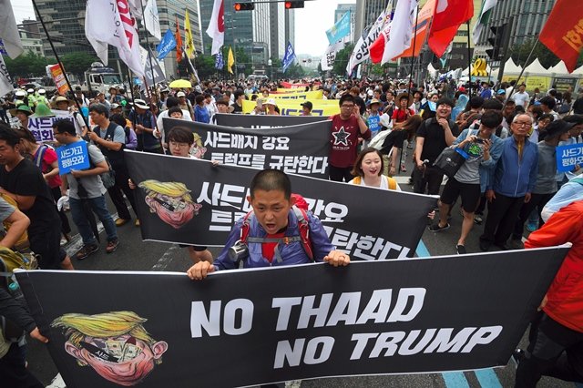 south korean protestors march toward the us embassy during a rally against the deployment of the us terminal high altitude area defense thaad system in seoul on june 24 2017 photo afp