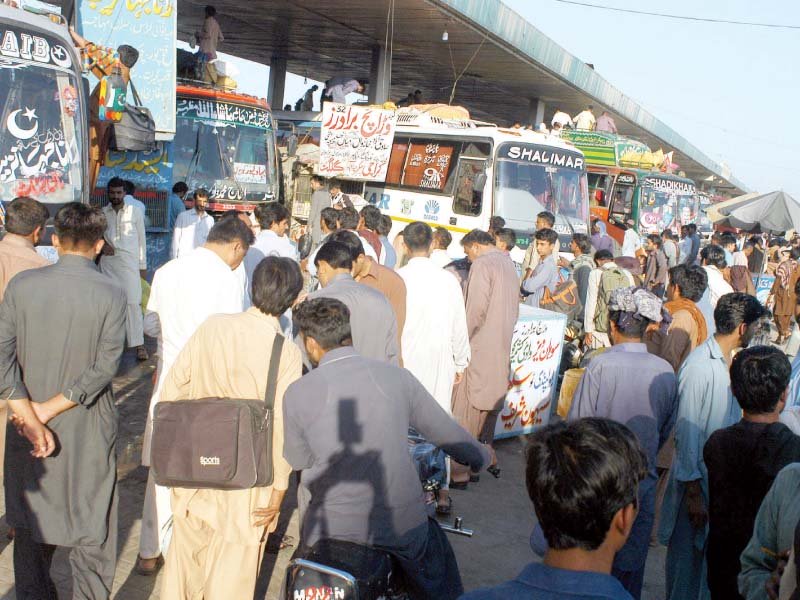 people rush to bus stands to head home for eidul fitr photo waseem imran express