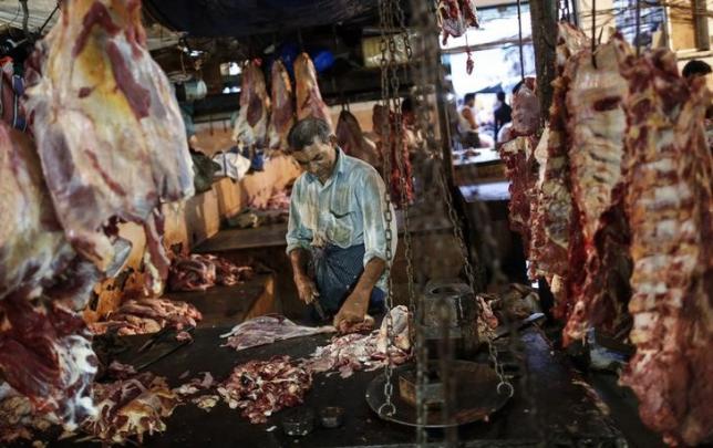 a butcher cuts up portions of beef for sale in an abattoir at a wholesale market in mumbai may 11 2014 photo reuters