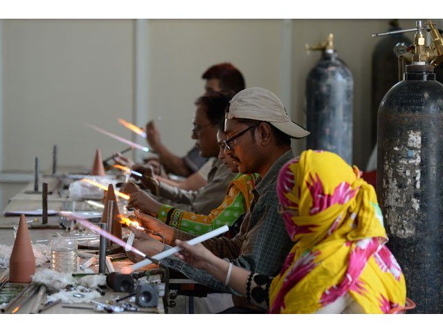 in this photograph taken on april 12 2017 indian artisans attend a government run training workshop to learn new techniques in glass art in firozabad photo afp