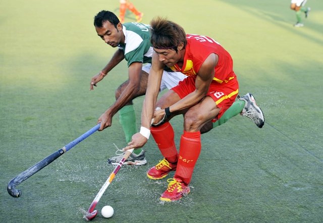 in this file photo liu yixian r of china vies for the ball with muhammad umar bhutta of pakistan during the third field hockey match between pakistan and china in faisalabad on december 24 2011 photo afp