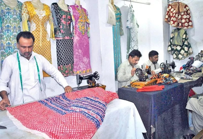 tailors busy at their workplace ahead of eidul fitr photo online tailors busy at their workplace ahead of eidul fitr photo online