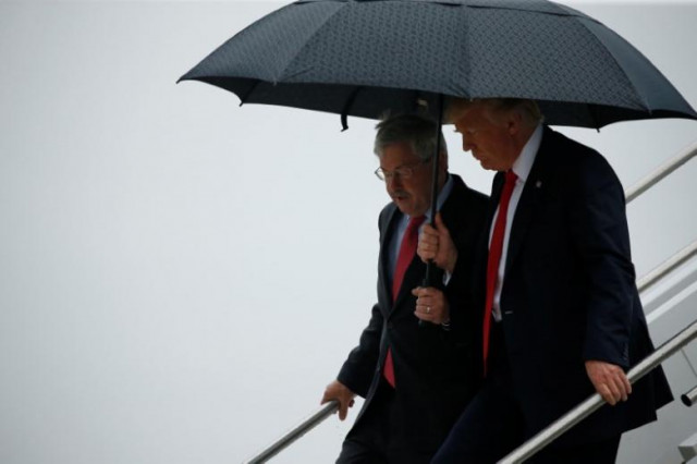 us president donald trump r holds an umbrella over us ambassador to china terry branstad former governor of iowa as they arrive together aboard air force one at eastern iowa airport in cedar rapids iowa us june 21 2017 photo reuters us president donald trump r holds an umbrella over us ambassador to china terry branstad former governor of iowa as they arrive together aboard air force one at eastern iowa airport in cedar rapids iowa us june 21 2017 photo reuters