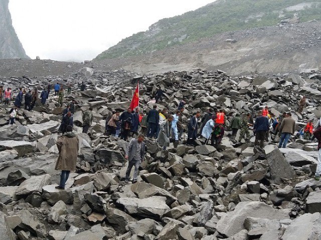 chinese military police and rescue workers are seen at the site of a landslide in in xinmo village diexi town of maoxian county sichuan province on june 24 2017 photo afp