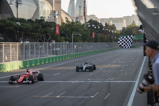 ferrari 039 s german driver sebastian vettel crosses the finish line ahead of mercedes 039 british driver lewis hamilton during the formula one azerbaijan grand prix at the baku city circuit photo afp ferrari 039 s german driver sebastian vettel crosses the finish line ahead of mercedes 039 british driver lewis hamilton during the formula one azerbaijan grand prix at the baku city circuit photo afp